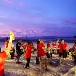 Jacobson team participating in a sunset drum circle during Team Building Phuket